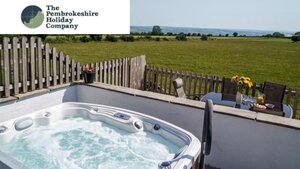 Case Study: The Pembrokeshire Holiday Company Hot tub - Photo of a hot tub filled with bubbling water in front of an open field.