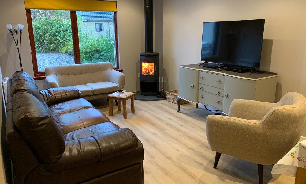 Living Room - The Noo - comfortable living room with wood burning stove, TV with Sky Movies and Sports (© The Noo)