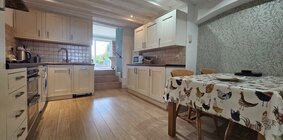 A fully equipped kitchen and dining room