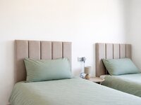 Minimalist twin beds in soft hues