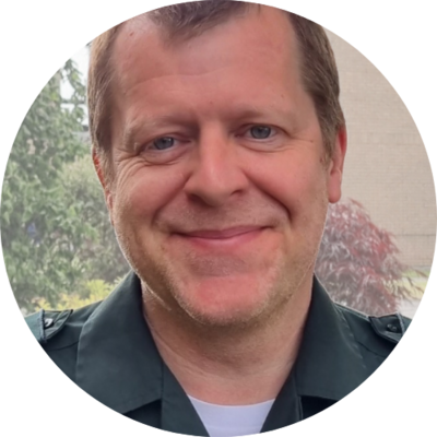 Andy McNicoll - Andy is a professional male with a closed mouth smile and stubble in a staff photo for Bookster Marketing Software.