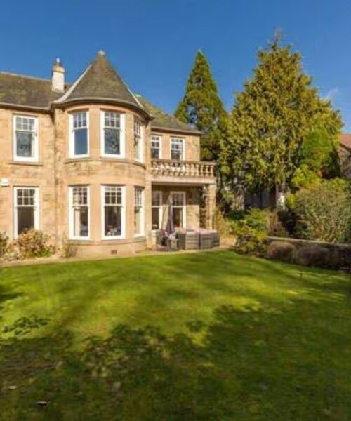 Stunning, Family-friendly Property - A stunning view of the home’s beautiful stone exterior surrounded by lush greenery