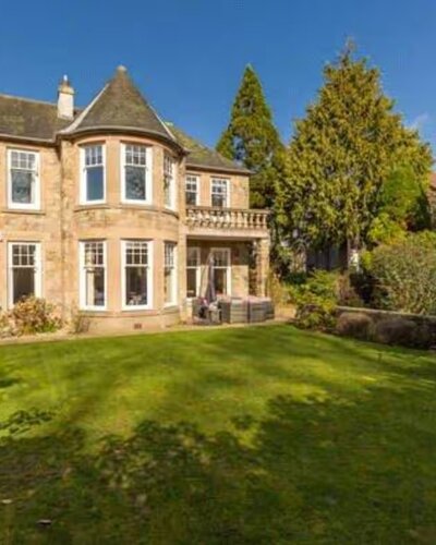 Stunning, Family-friendly Property - A stunning view of the home’s beautiful stone exterior surrounded by lush greenery
