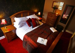 Ladystairs bedroom with kingsize bed