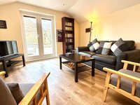 Living area with patron doors leading to outdoor space.