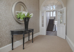 Well-lit staircase to the Entrance Hall