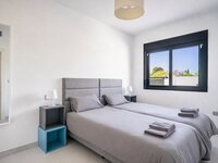 Minimalist twin bedroom with natural light