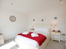 Law View - Bright double bedroom, with side tables and lamps, in North Berwick self catering apartment.