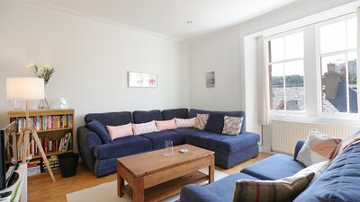 Law View - Comfy living room with views and featuring well stocked book case, in North Berwick holiday home.