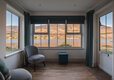 The spacious sun room looking out on to the sea and the mountails