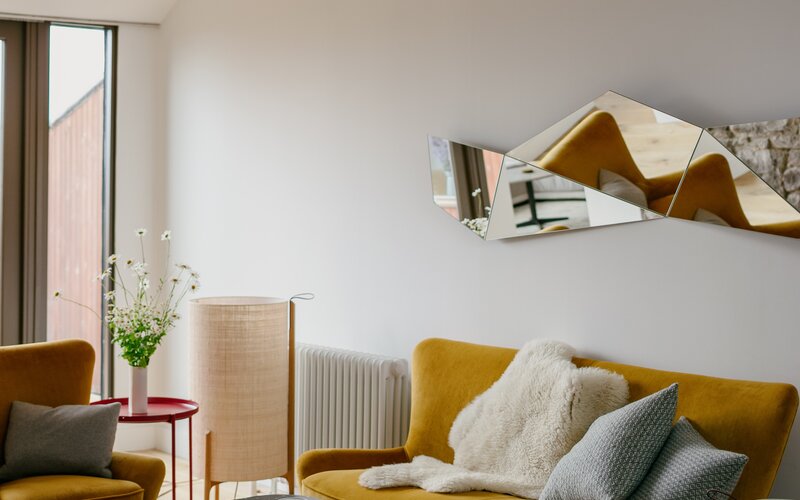 Stylish Living Room in a Holiday Home - Beautiful living room with a pop of colour. Relax with your family after a long day of sightseeing.