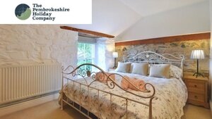 Case Study: The Pembrokeshire Holiday Company Bedroom - Photo of a double bed in a light and airy room.