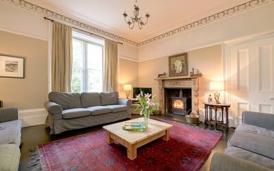 Cosy Lounge in a Self-Catered Home - Inviting living room featuring comfortable seating, stylish décor and a wood burner