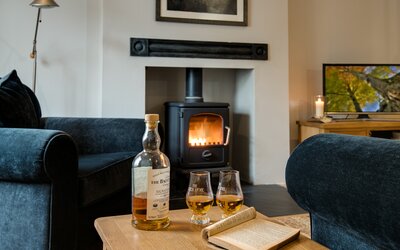 Warm Lounge  in Luxury Holiday Let - Cosy and spacious room featuring  ample comfy seating, a fireplace and TV