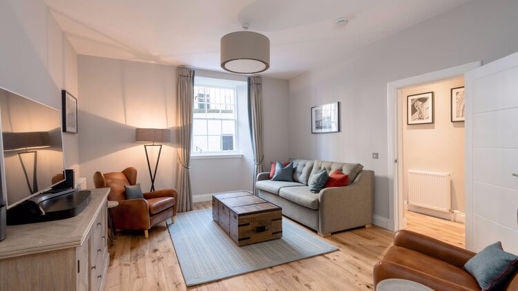 Stafford Street Apartment Lounge - Spacious lounge with grey and brown colour scheme in Edinburgh West End apartment.