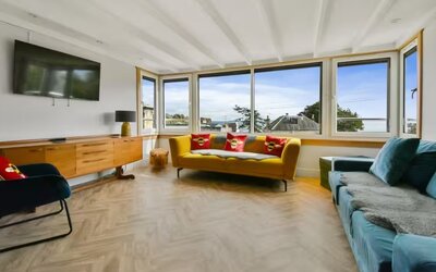 Spacious Living Room with High Speed Internet - Bask in tranquillity in this sun-filled living room, surrounded by lush greenery and serene sea views