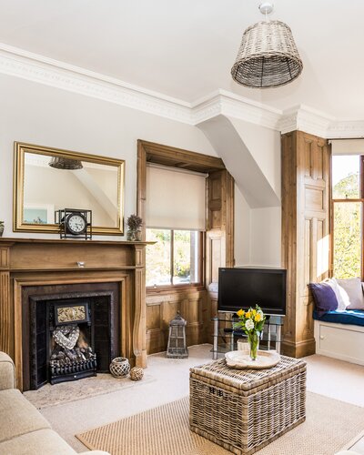 GILLIAN THE NEUK 23.04.26-17 - Bright and spacious living room at The Neuk Apartment in North Berwick with large bay windows, comfortable sofas and cosy seating area.