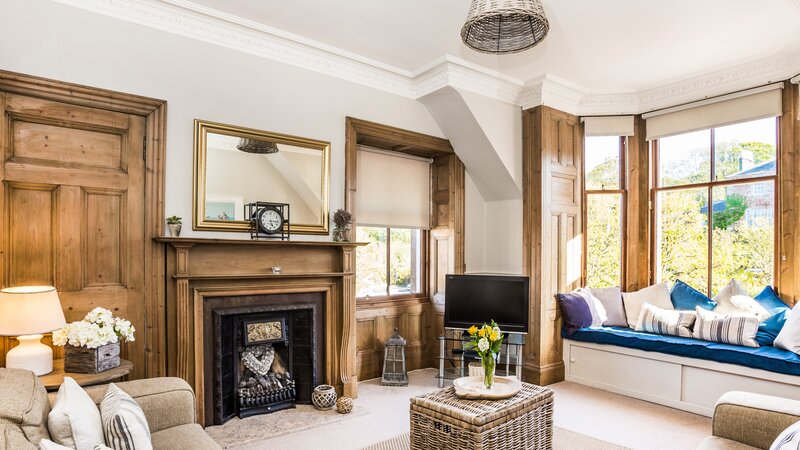 GILLIAN THE NEUK 23.04.26-17 - Bright and spacious living room at The Neuk Apartment in North Berwick with large bay windows, comfortable sofas and cosy seating area.