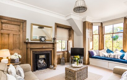 GILLIAN THE NEUK 23.04.26-17 - Bright and spacious living room at The Neuk Apartment in North Berwick with large bay windows, comfortable sofas and cosy seating area.