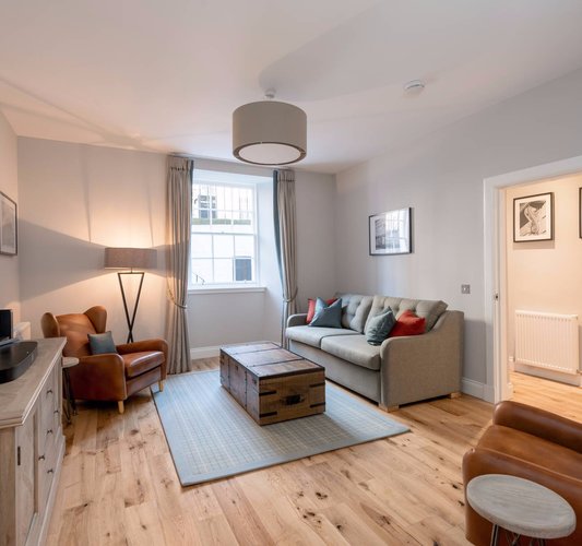 Stafford Street Apartment Lounge - Spacious lounge with grey and brown colour scheme in Edinburgh West End apartment.