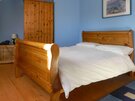 Castle Cottage-12 - Double bedroom with wooden bed frame and large wooden wardrobe