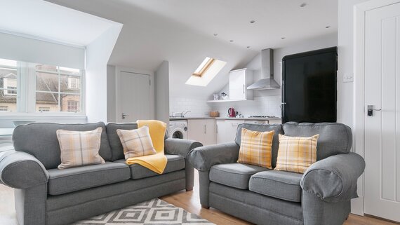 Edinburgh-Flats-holiday-rental-Royal-Mile-High-Street-lounge - Bright spacious Living/Dining/Kitchen open plan area with lovely wooden floors and 2 modern grey sofa and a double sofa bed which sleeps 2 people