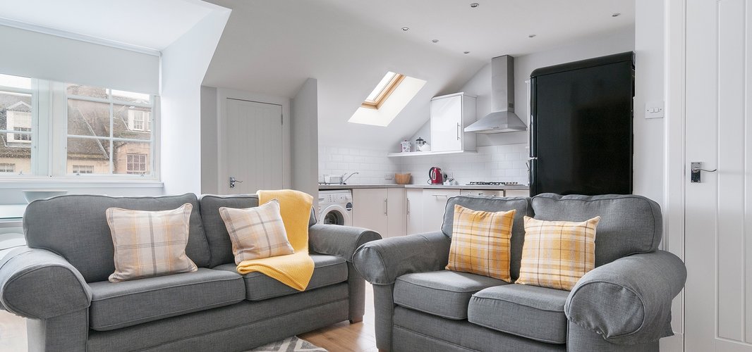 Edinburgh-Flats-holiday-rental-Royal-Mile-High-Street-lounge - Bright spacious Living/Dining/Kitchen open plan area with lovely wooden floors and 2 modern grey sofa and a double sofa bed which sleeps 2 people