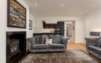 Living Room/Kitchen - Open plan contemporary kitchen and living space featuring a log stove and fireplace in Edinburgh. holiday home.