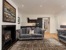 Living Room/Kitchen - Open plan contemporary kitchen and living space featuring a log stove and fireplace in Edinburgh. holiday home.