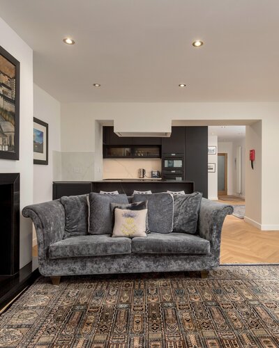 Living Room/Kitchen - Open plan contemporary kitchen and living space featuring a log stove and fireplace in Edinburgh. holiday home.