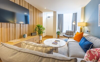 Living Room - An inviting living room designed with modern travellers in mind. It features comfortable seating and stylish furnishings, creating a relaxing atmosphere in the heart of the city.