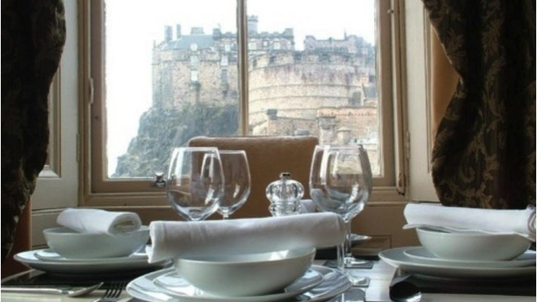 CastleEsplanade_01 - Detail of family dining table with view to Edinburgh Castle
