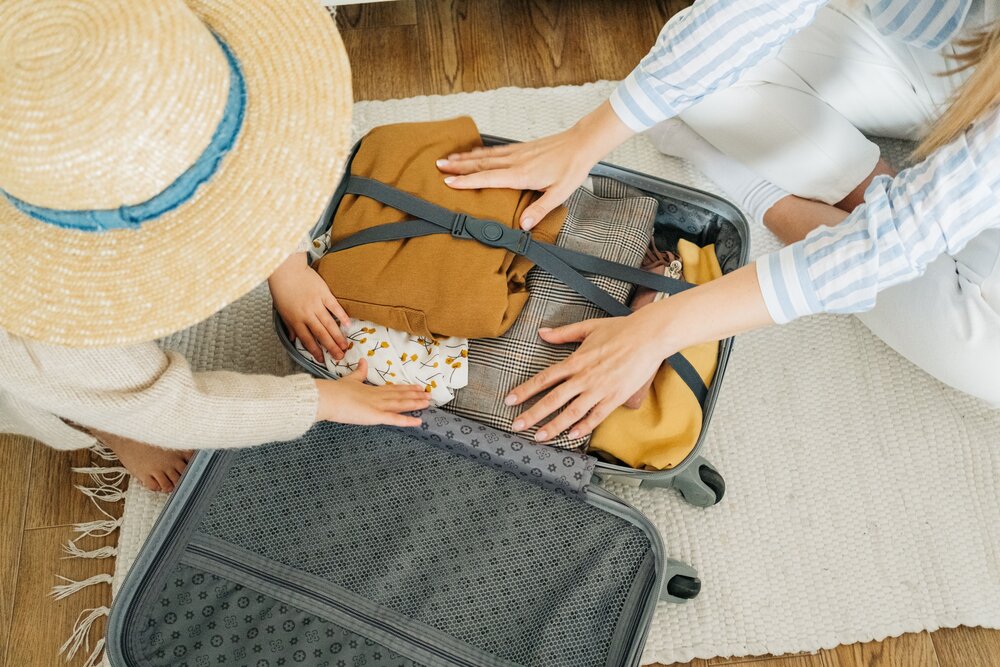 Prevent price rises affecting Staycation costs - Two people packing a suitcase for a staycation (© Ivan Samkov)