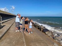 Family on the sea wall at Eccles on Sea