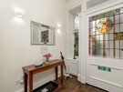Victorian stained glass entrance vestibule in Edinburgh holiday home - White front door in bright, airy entrance hall with entrance vestibule and stained glass window