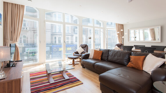 Lounge Area in a Self-Catered Apartment - Stylish lounge area with comfortable sofas, to unwind after a long day in the city of Edinburgh