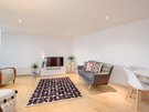 Sandport Way 3 - Spacious, contemporary open plan living room / dining area, featuring designer rug and cushions in an  Edinburgh holiday apartment.