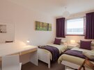 Twin Bedroom - Double size bedroom with twin beds, large dressing table, and mirror in self-catering accommodation, Edinburgh.