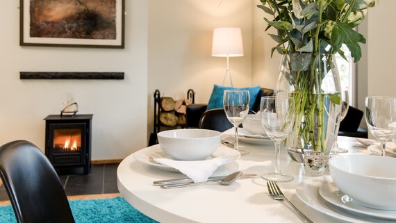 Cosy Dining Room in a Corporate Stay - Congregate in the dining room, where sumptuous seating and ambient décor create a welcoming atmosphere