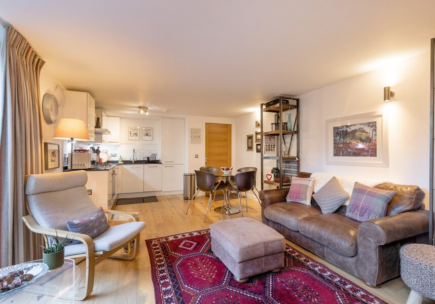 open plan kitchen with a cosy sitting/dining area