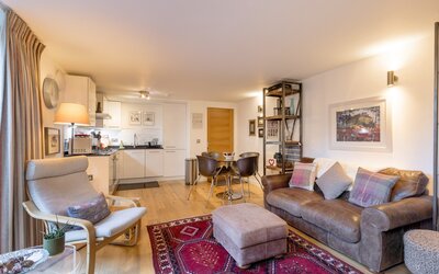 open plan kitchen with a cosy sitting/dining area - The open plan ground floor offers a cosy sitting/dining area with sliding doors opening into the garden as well as a fully equipped kitchen area