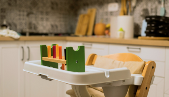 Stay - A highchair in a kitchen with baby blocks on the highchair table (© @eugenivy_now)