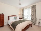 Holyrood Road 4 - Double bedroom with decorative owl cushion and plentiful guest storage