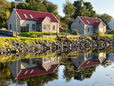 The two Dornie Croft cottages reflected in the sea