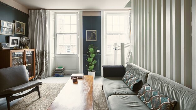 Bright Living Room Area in Scotland - Cosy lounge featuring a large dark-coloured sofa, a rustic table and stunning views