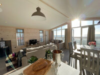 Open plan living room and dining room in a holiday lodge