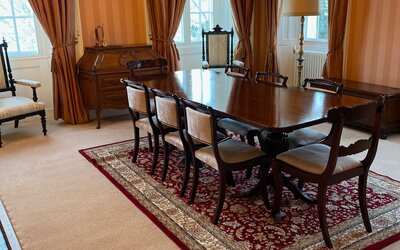 Dining Room in a Holiday Home Near Loch Tay - Elegant and spacious dining room with a wooden table, comfy chairs and ambient lighting