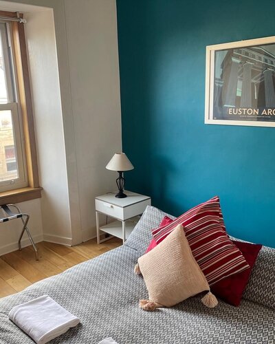Double bedroom 1 in holiday accommodation on Lothian Road, Edinburgh - Blue double bedroom 1 with double bed and window.