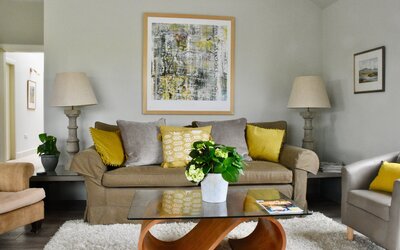 Living room no lights2 - Sofa and cushions, side tables and tall lamps in Haddington holiday home.