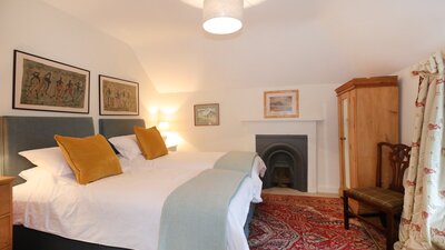 Balgone Coach House - double bedroom - Double bedroom with traditional fireplace at Balgone Coach House, a North Berwick holiday let
